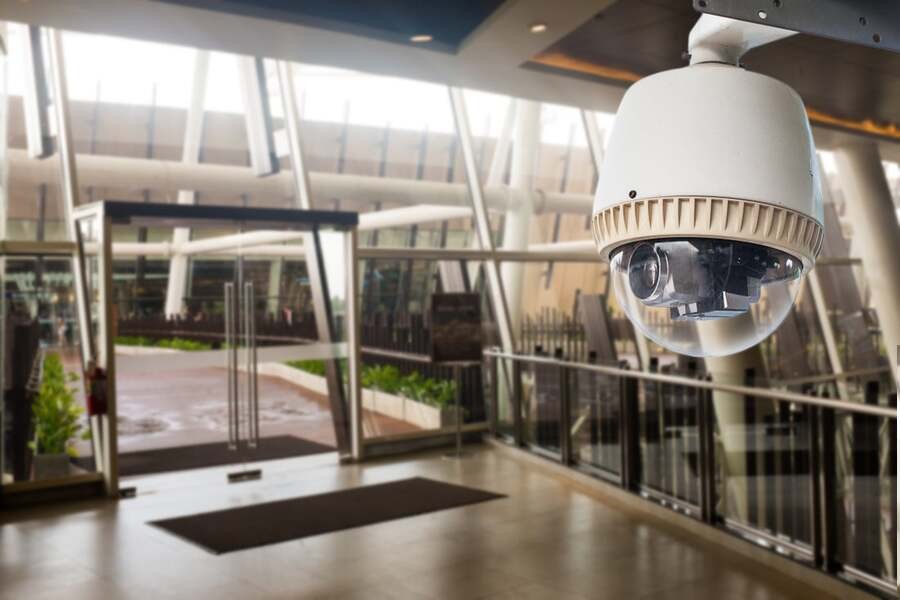 A commercial surveillance camera providing coverage for lobby entranceway.