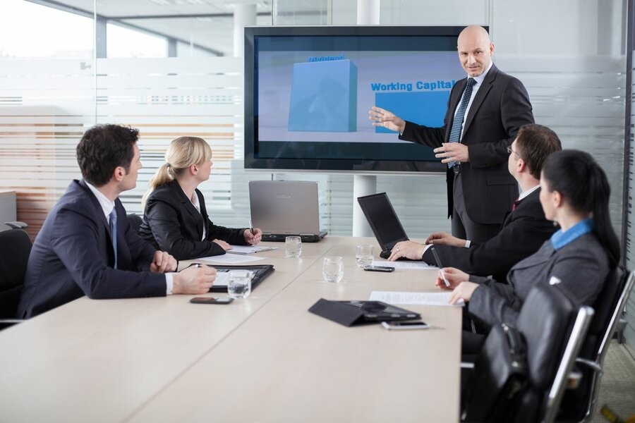 A collaborative meeting in a conference room featuring AV solutions.