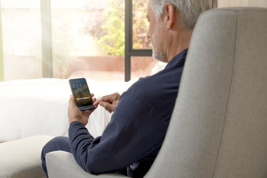 A man accessing his Savant smart home automation interface via his smartphone.