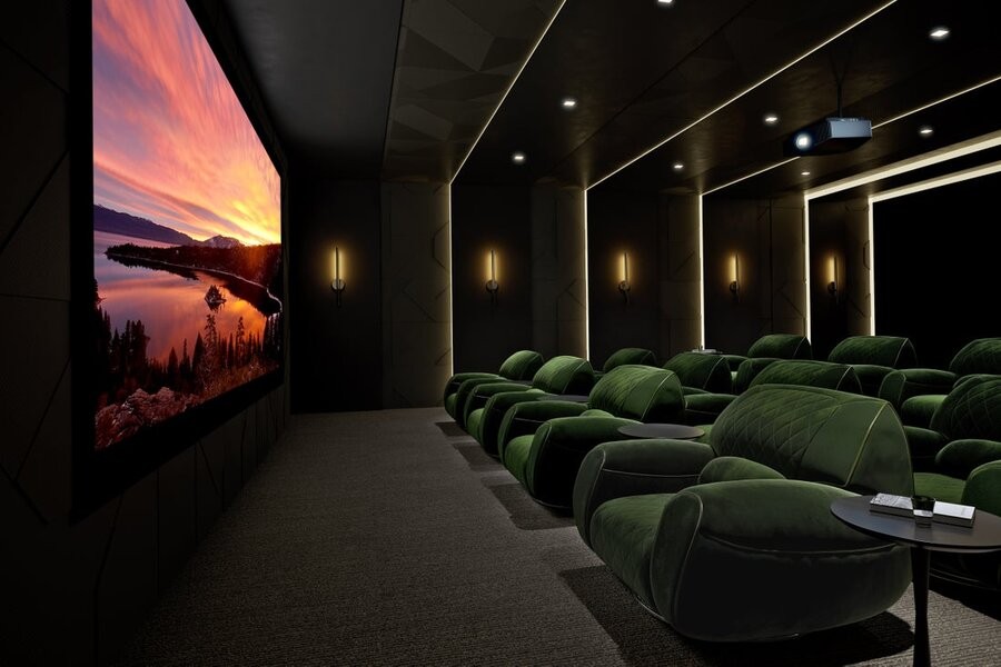 A luxurious home theater installation and setup from Sony with a large display and comfy seating.