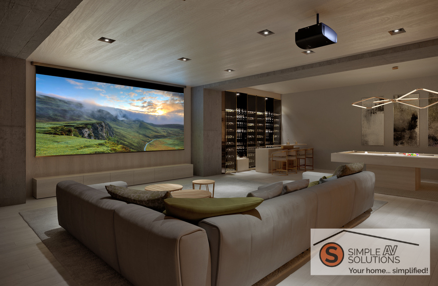 A casual home theater with a sectional, wine bar, pool table, large movie screen, and Sony projector with the Simple AV Solutions logo in the bottom right corner.