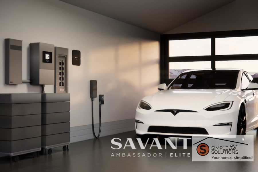 A white car charges in a garage near a Savant power system with the Simple AV Solutions logo in the bottom right corner.