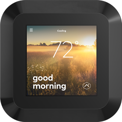 A close-up of an Alarm.com smart thermostat with a sleek display showing the current temperature and greeting “Good Morning.”