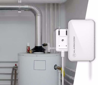 A water heater with an Alarm.com leak detection sensor, providing early warning alerts for water damage prevention.